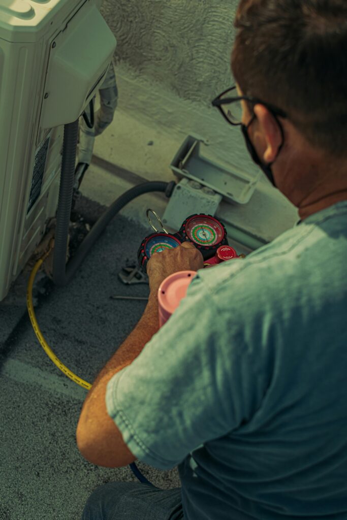 Technician checking if AC needs repair